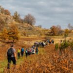 A group of people enjoy hiking through an autumn landscape near Belgrade, Serbia.