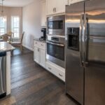 Spacious modern kitchen featuring stainless steel appliances and a dining area.